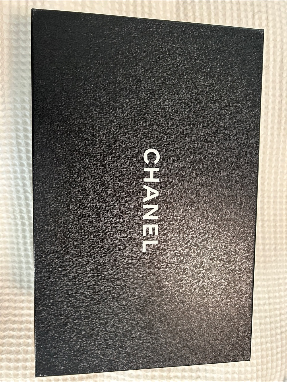 Chanel box - likely phone accessory packaging